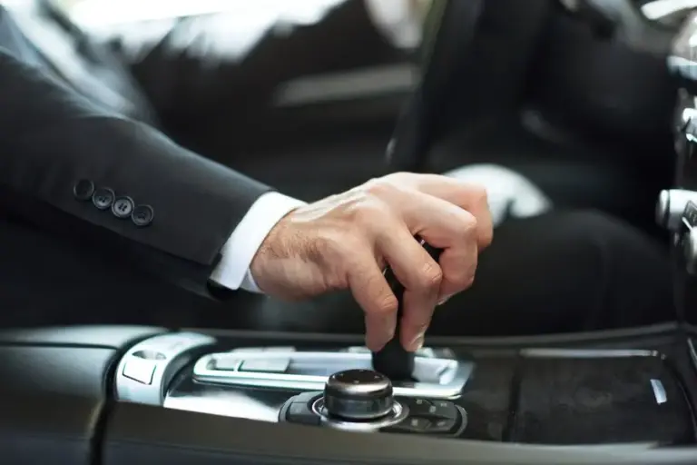 businessman-driving-his-car-background-close-up-human-hand-holding- Limo Service in Katy TX